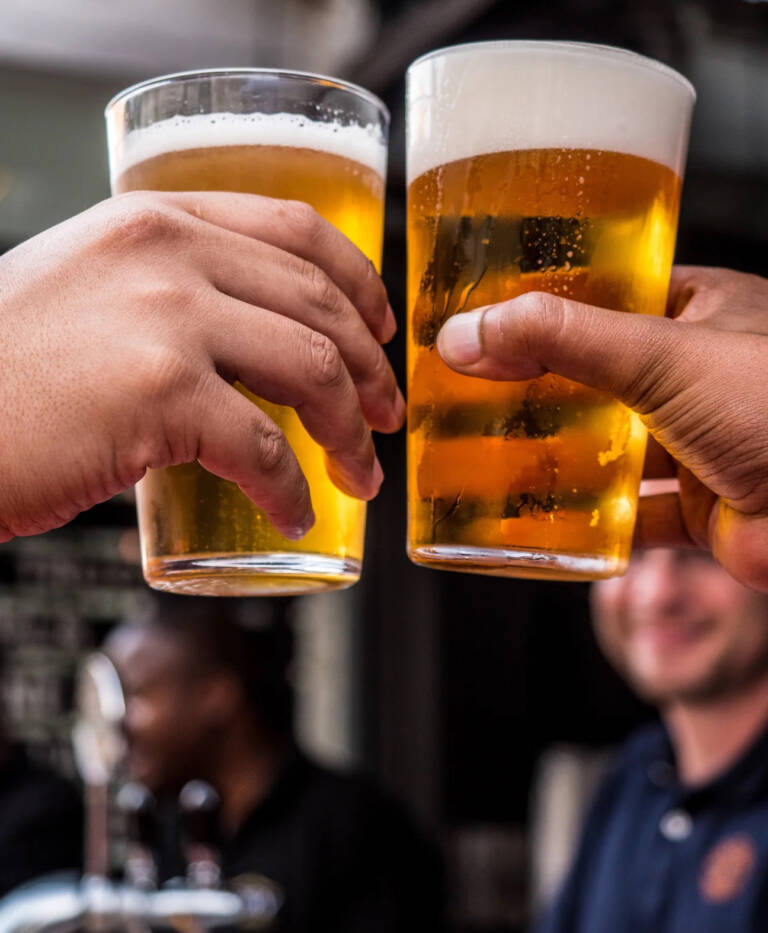 Cheering with pint glasses at Patriot Pub & Gaming