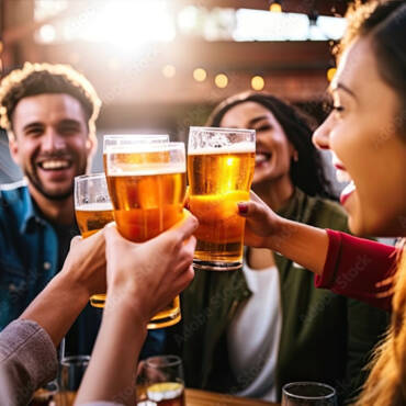 People laughing an cheering with beer glasses